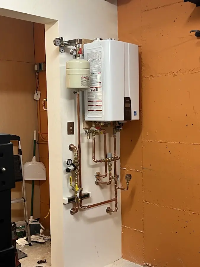 Plumbing technician inspecting water heater connections in Lake View